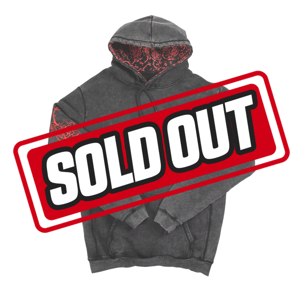 Black hoodie sleeve with intricate bright red embroidered twisted rose and thorn design.